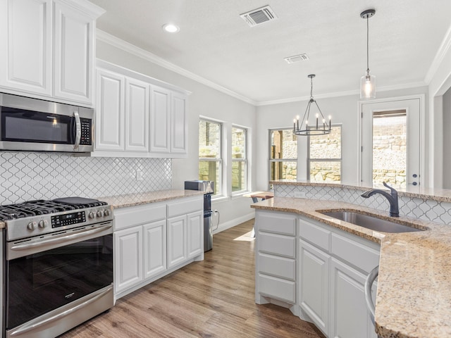 1317 Thistle Hill Trl, Weatherford, TX 76087 - kitchen with a notable chandelier, light wood-style flooring, visible vents, stainless steel appliances, and a sink
