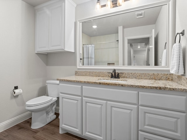 1317 Thistle Hill Trl, Weatherford, TX 76087 - bathroom with vanity, visible vents, toilet, wood finished floors, and baseboards