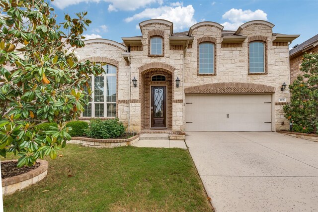 view of front facade featuring a garage, a front lawn, driveway, and stone siding