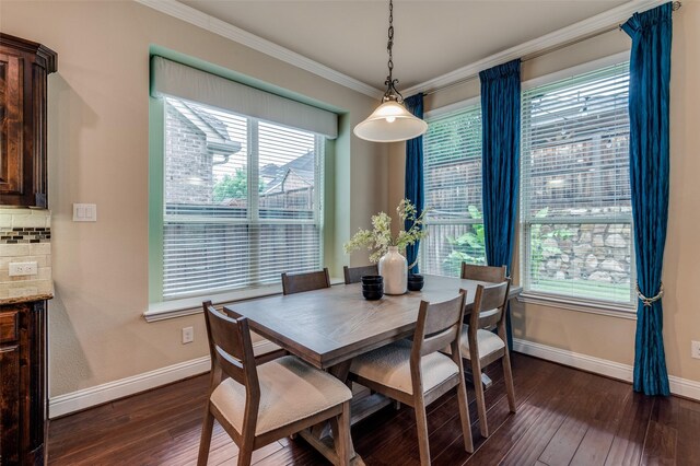 dining space with baseboards, ornamental molding, plenty of natural light, and dark wood-style floors