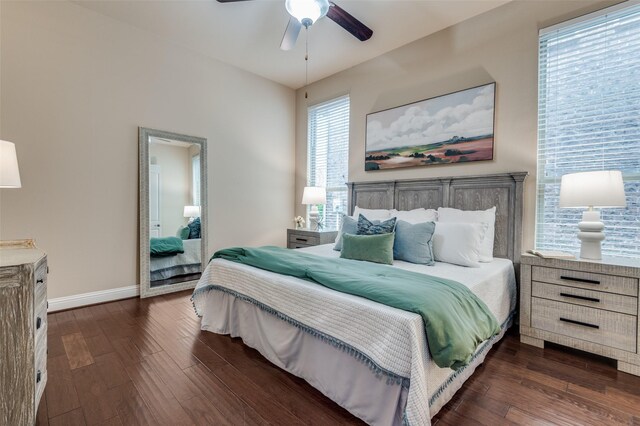bedroom with baseboards, a ceiling fan, and dark wood-style flooring