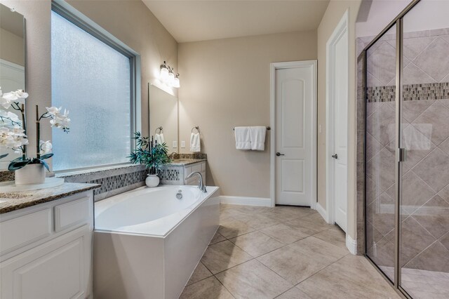 bathroom featuring vanity, a bath, and a stall shower