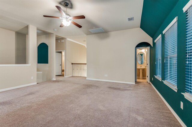 carpeted spare room featuring visible vents, baseboards, ceiling fan, and lofted ceiling