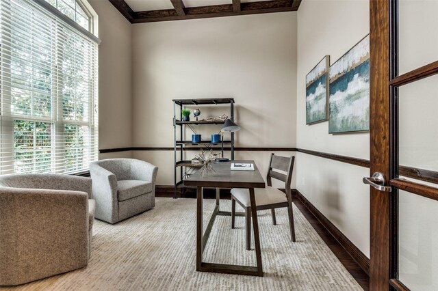 office area with baseboards, coffered ceiling, beam ceiling, and wood finished floors