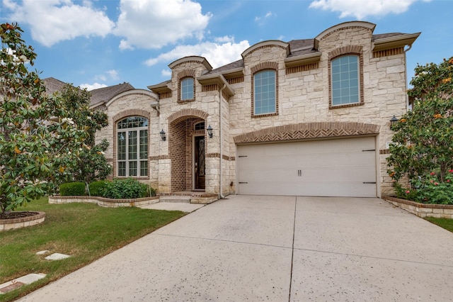 view of front facade featuring concrete driveway, an attached garage, stone siding, and a front lawn