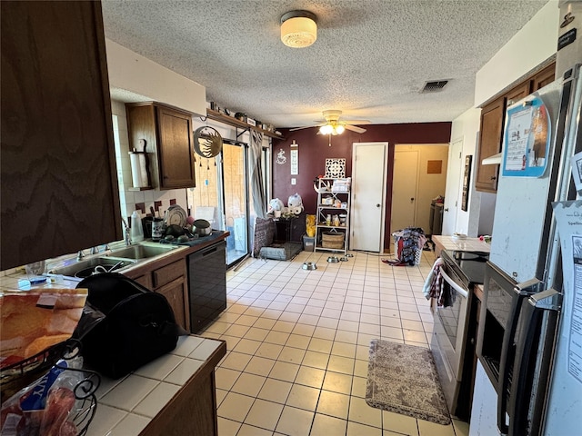 2205 Meadow Ln, Garland, TX 75040 - kitchen with electric range, dishwasher, tile countertops, light tile patterned floors, and visible vents