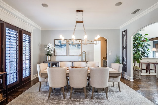 2890 Creekwood Ln, Prosper, TX 75078 - dining space with a chandelier, arched walkways, wood finished floors, and crown molding