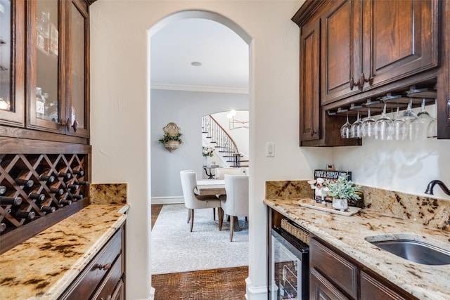2890 Creekwood Ln, Prosper, TX 75078 - indoor wet bar with stairs, arched walkways, crown molding, and wine cooler