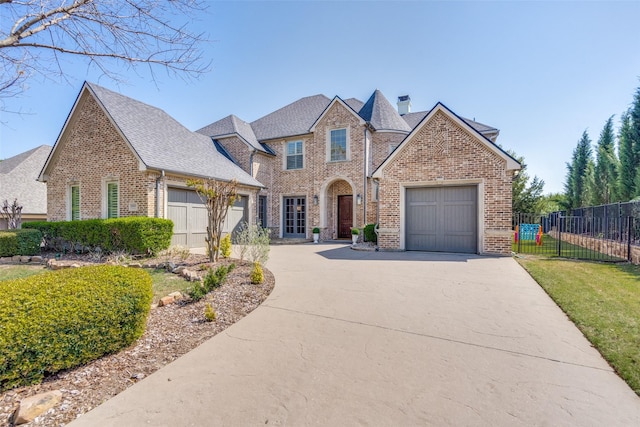 2890 Creekwood Ln, Prosper, TX 75078 - view of front of home featuring brick siding, driveway, a shingled roof, an attached garage, and a chimney