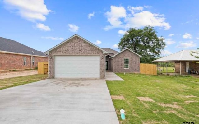 109 Baker St, Mount Vernon, TX 75457 - view of front facade with concrete driveway, an attached garage, and brick siding