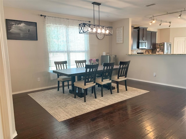 9140 Blackstone Dr, Providence Village, TX 76227 - dining room with a chandelier, dark wood-type flooring, visible vents, and baseboards