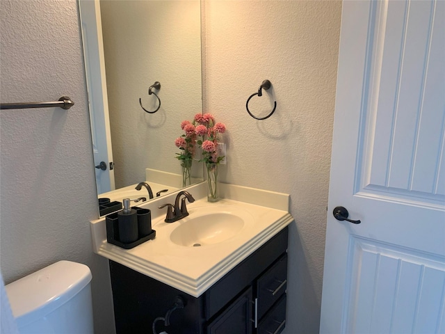 9140 Blackstone Dr, Providence Village, TX 76227 - bathroom featuring toilet, vanity, and a textured wall