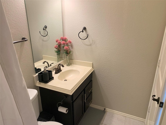 9140 Blackstone Dr, Providence Village, TX 76227 - bathroom featuring vanity, baseboards, a textured wall, tile patterned floors, and toilet