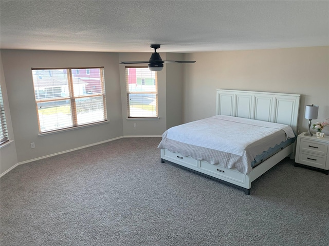 9140 Blackstone Dr, Providence Village, TX 76227 - unfurnished bedroom with a textured ceiling, dark colored carpet, and baseboards