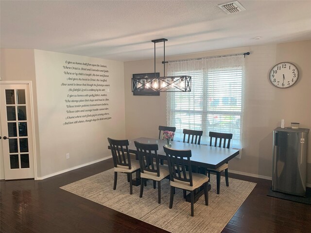 9140 Blackstone Dr, Providence Village, TX 76227 - dining room featuring dark wood-type flooring, visible vents, baseboards, and a notable chandelier