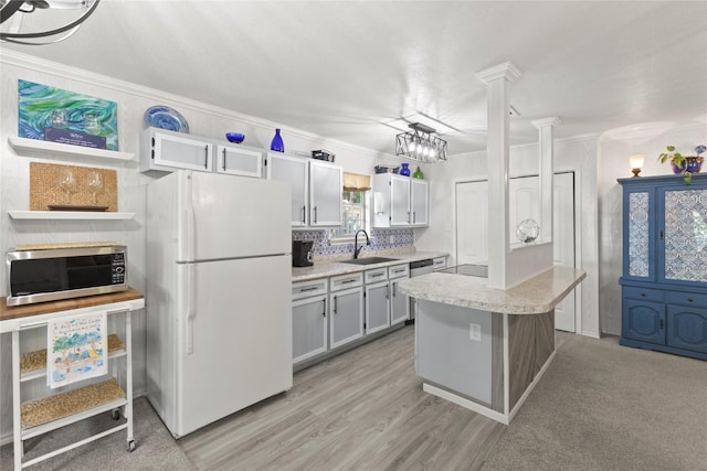281 Harbor Dr, Gun Barrel City, TX 75156 - kitchen featuring stainless steel appliances, a sink, crown molding, tasteful backsplash, and decorative columns