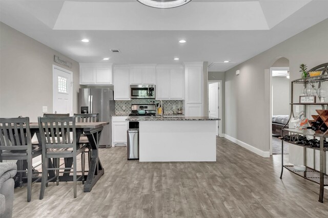 530 E Day St, Denison, TX 75021 - kitchen featuring stone countertops, white cabinetry, decorative backsplash, and appliances with stainless steel finishes