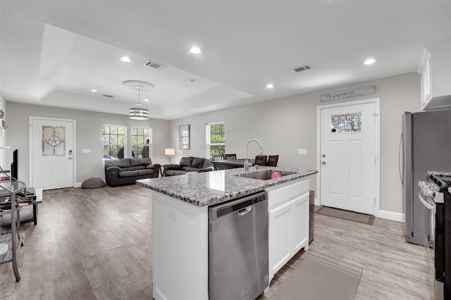 530 E Day St, Denison, TX 75021 - kitchen featuring a raised ceiling, visible vents, a sink, and appliances with stainless steel finishes