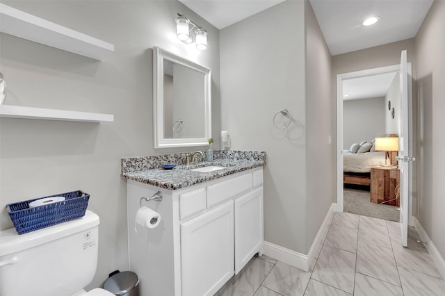 530 E Day St, Denison, TX 75021 - ensuite bathroom featuring vanity, marble finish floor, baseboards, and toilet