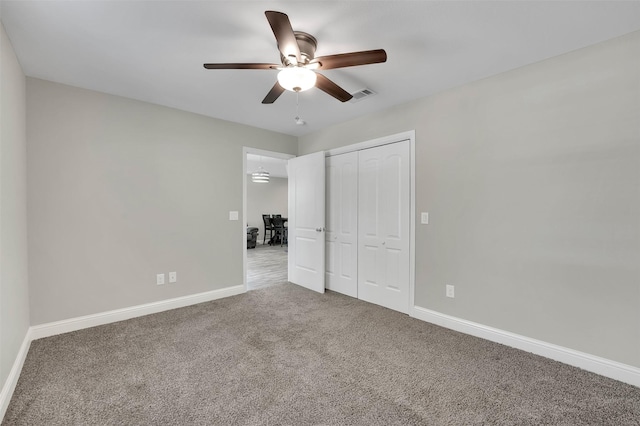530 E Day St, Denison, TX 75021 - unfurnished bedroom featuring a closet, baseboards, a ceiling fan, visible vents, and carpet