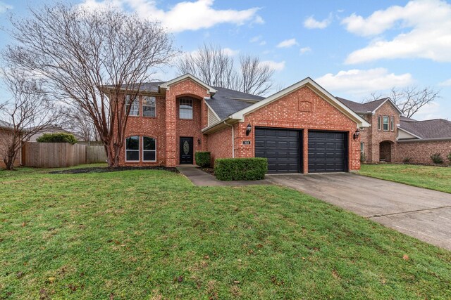 322 Ashley Oak Ln, Lake Dallas, TX 75065 - traditional-style house featuring a garage, aphalt driveway, brick siding, and fence