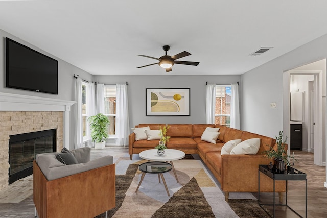 322 Ashley Oak Ln, Lake Dallas, TX 75065 - living room featuring a glass covered fireplace, plenty of natural light, visible vents, and a ceiling fan