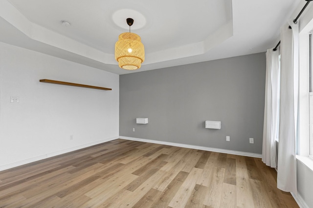 322 Ashley Oak Ln, Lake Dallas, TX 75065 - spare room featuring light wood finished floors, baseboards, and a raised ceiling