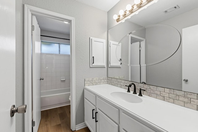 322 Ashley Oak Ln, Lake Dallas, TX 75065 - full bathroom featuring a textured wall, vanity, visible vents, and wood finished floors