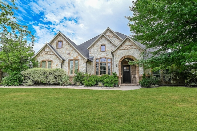 5454 Pebble Creek Dr, Celina, TX 75078 - french country style house featuring brick siding, a front lawn, and stone siding
