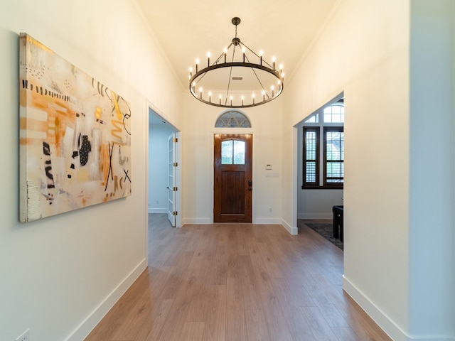 5454 Pebble Creek Dr, Celina, TX 75078 - foyer featuring crown molding, baseboards, an inviting chandelier, and wood finished floors