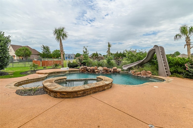 5454 Pebble Creek Dr, Celina, TX 75078 - view of pool with a pool with connected hot tub, a water slide, and fence