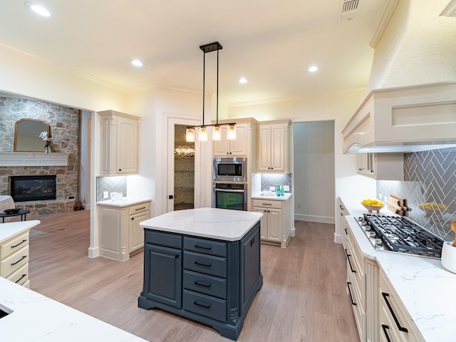 5454 Pebble Creek Dr, Celina, TX 75078 - kitchen featuring visible vents, a stone fireplace, light wood-type flooring, and stainless steel appliances