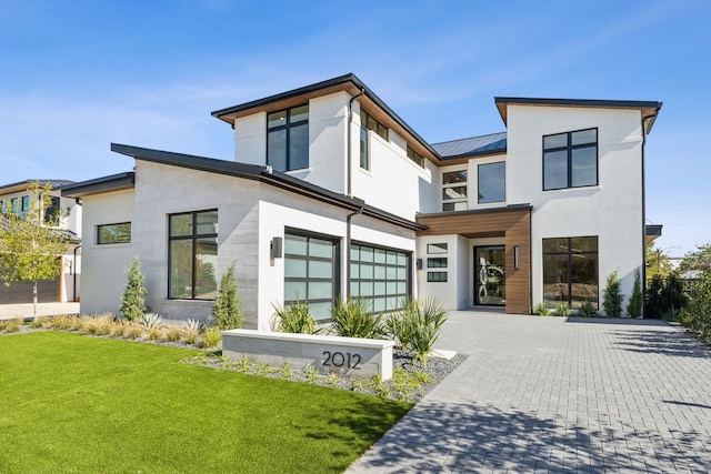 2012 Whitwood Cv, Westlake, TX 76262 - contemporary home featuring an attached garage, decorative driveway, a front lawn, stucco siding, and metal roof