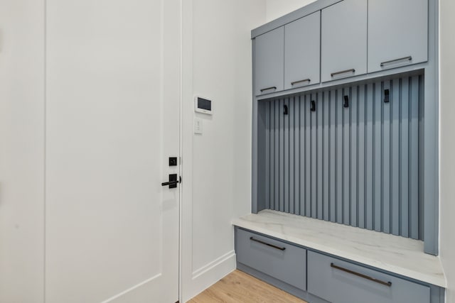 mudroom with light wood-style flooring and baseboards