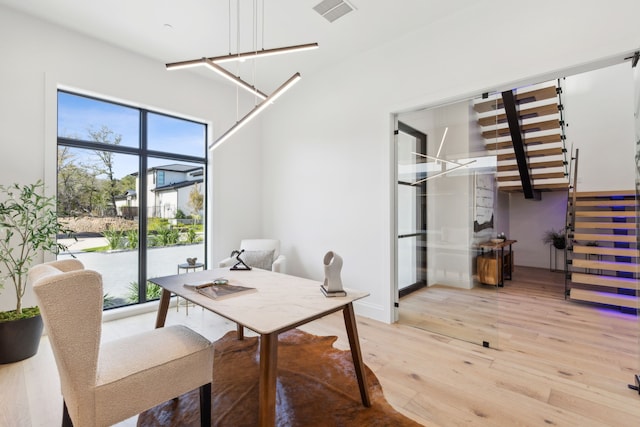 office featuring a healthy amount of sunlight, light wood-style flooring, and visible vents