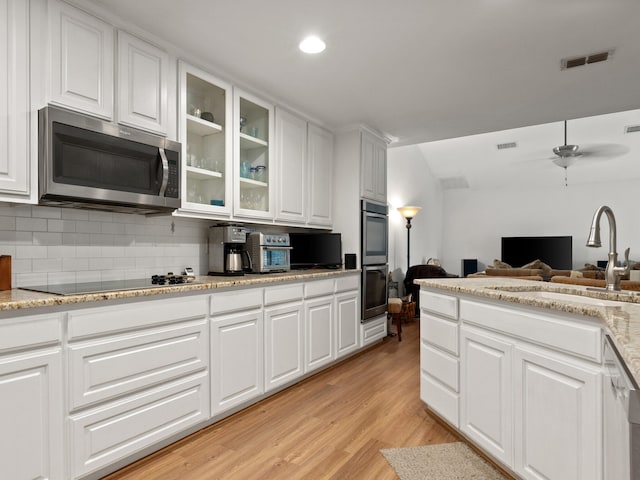 6504 Lago Vista Dr, Benbrook, TX 76132 - kitchen with visible vents, glass insert cabinets, light wood-style floors, white cabinetry, and stainless steel appliances