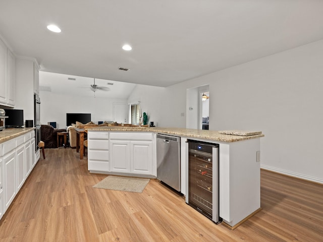 6504 Lago Vista Dr, Benbrook, TX 76132 - kitchen with open floor plan, wine cooler, light wood-style floors, ceiling fan, and stainless steel dishwasher