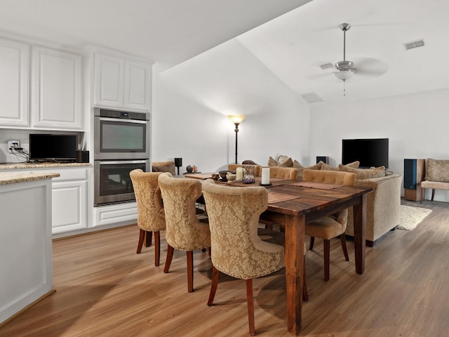6504 Lago Vista Dr, Benbrook, TX 76132 - dining room with light wood finished floors, visible vents, a ceiling fan, and lofted ceiling
