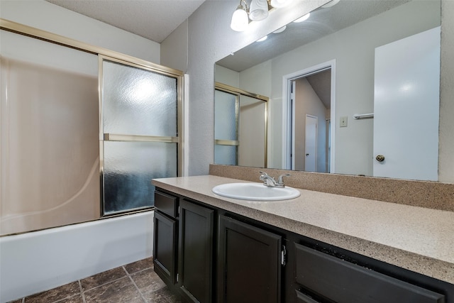 6605 Bluebonnet Dr, Rowlett, TX 75089 - bathroom with vanity, combined bath / shower with glass door, and stone finish flooring