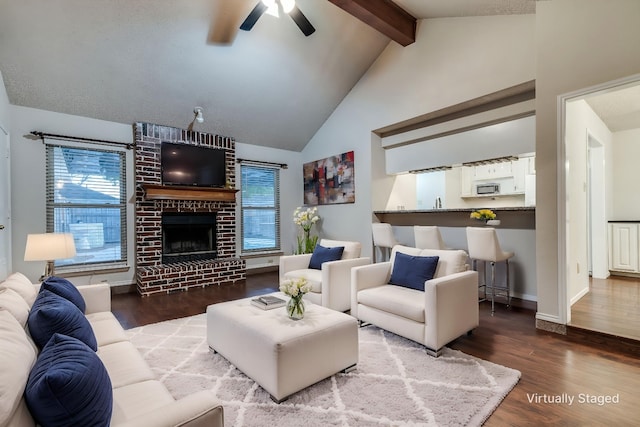 6605 Bluebonnet Dr, Rowlett, TX 75089 - living area featuring a brick fireplace, beamed ceiling, ceiling fan, wood finished floors, and baseboards