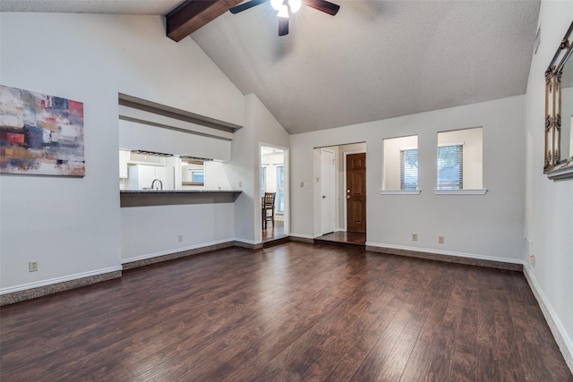 6605 Bluebonnet Dr, Rowlett, TX 75089 - unfurnished living room featuring ceiling fan, dark wood-style flooring, beamed ceiling, high vaulted ceiling, and baseboards