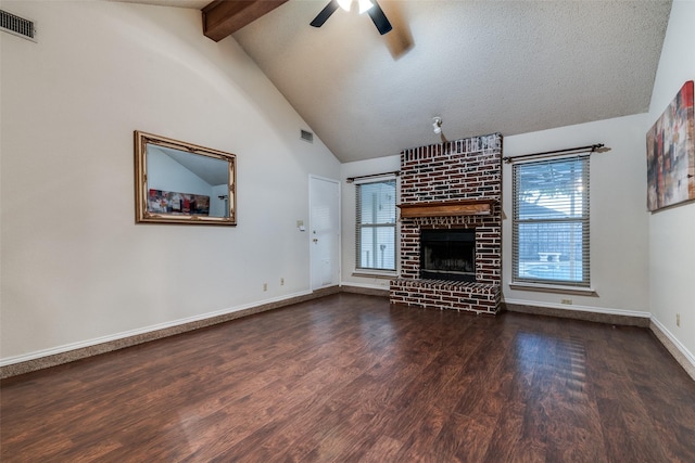 6605 Bluebonnet Dr, Rowlett, TX 75089 - unfurnished living room with a ceiling fan, wood finished floors, a brick fireplace, plenty of natural light, and beamed ceiling