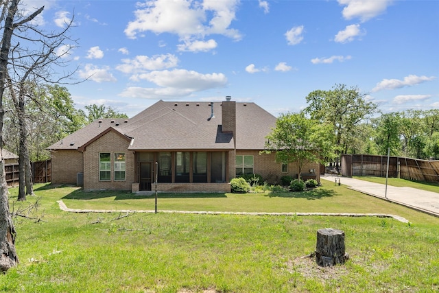 7217 Deer Field Dr, Mansfield, TX 76063 - rear view of house featuring brick siding, fence, a shingled roof, and a lawn