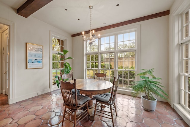 dining space featuring beam ceiling, baseboards, and an inviting chandelier