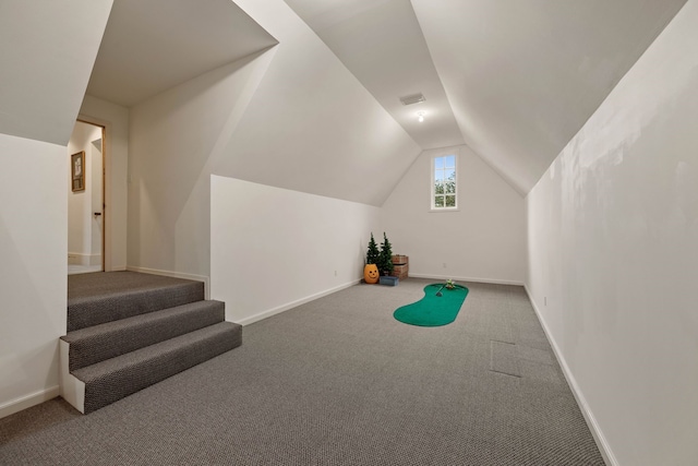 interior space with carpet, baseboards, and lofted ceiling