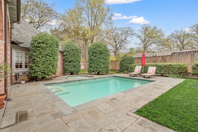 view of pool with a patio, an in ground hot tub, and fence
