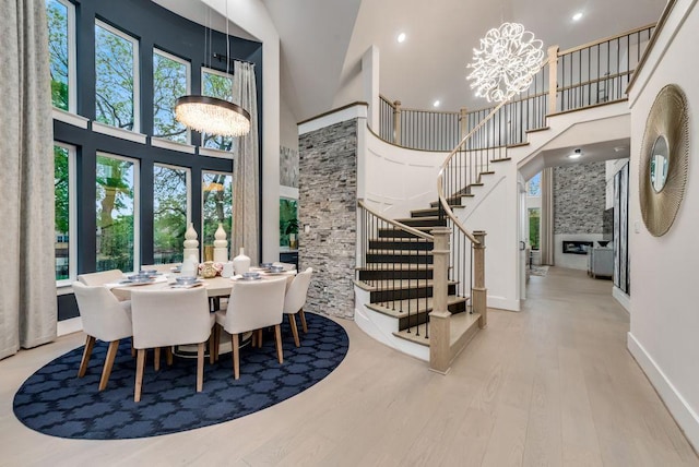 8602 Watersway Dr, Rowlett, TX 75088 - dining room featuring a high ceiling, wood finished floors, a chandelier, stairway, and recessed lighting