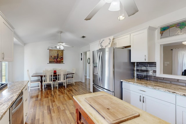 5609 Cedar Creek Dr, Kemp, TX 75143 - kitchen with ceiling fan, stainless steel appliances, light wood finished floors, white cabinetry, and decorative backsplash