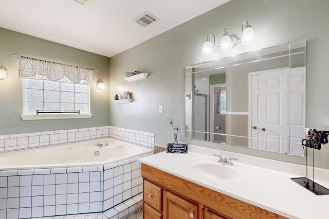 5609 Cedar Creek Dr, Kemp, TX 75143 - bathroom with healthy amount of natural light, a garden tub, and vanity