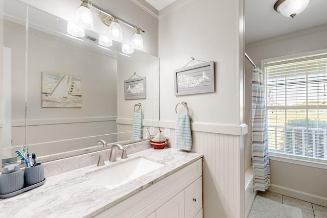 5609 Cedar Creek Dr, Kemp, TX 75143 - full bathroom featuring tile patterned flooring, crown molding, vanity, a wainscoted wall, and shower / tub combo with curtain
